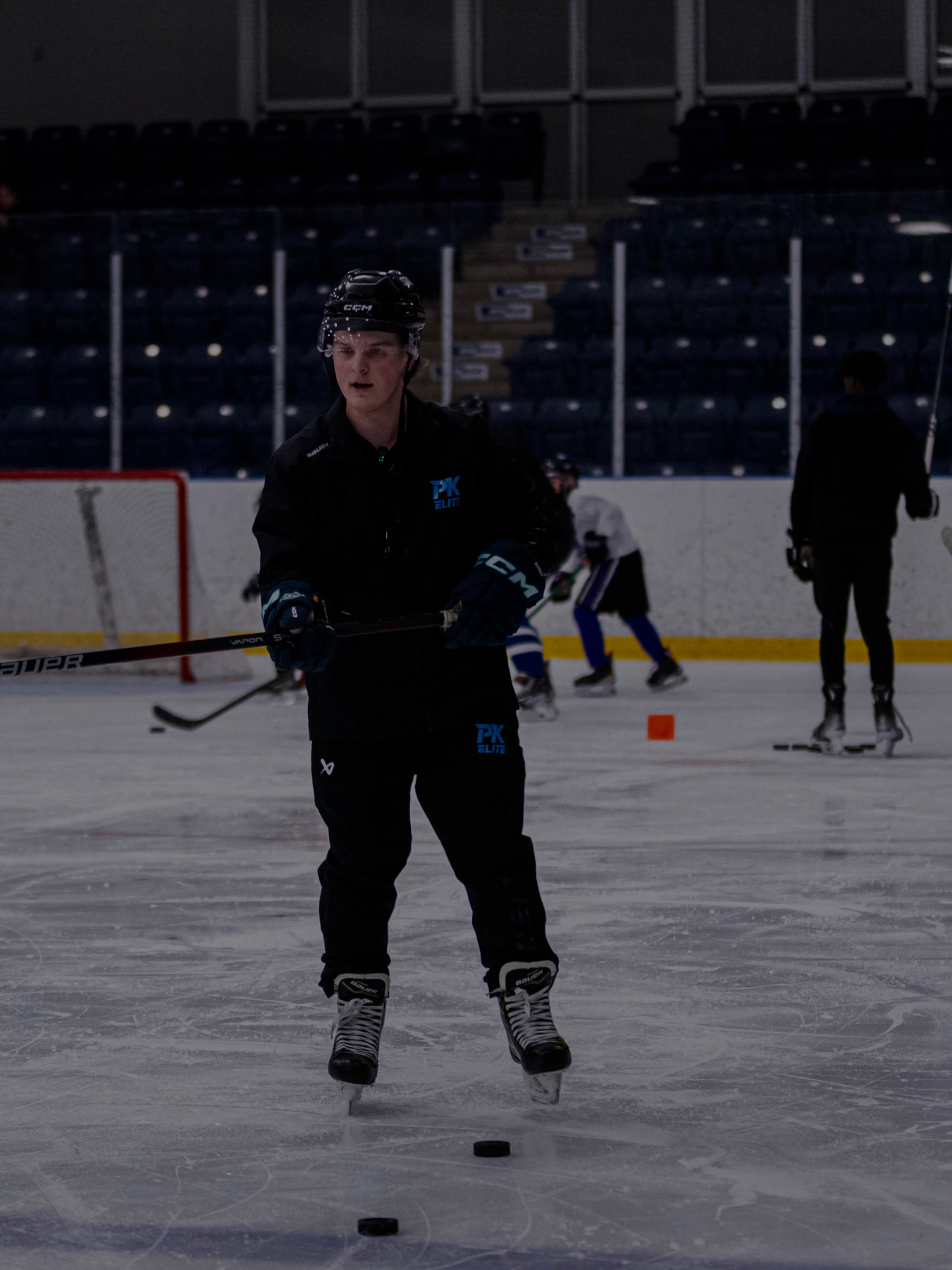 Coach Peter of PK Elite Hockey standing on the ice at the boards